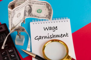 Paper with Wage Garnishment on a table.