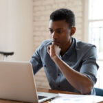 Concerned student loan borrower reading news about DOGE