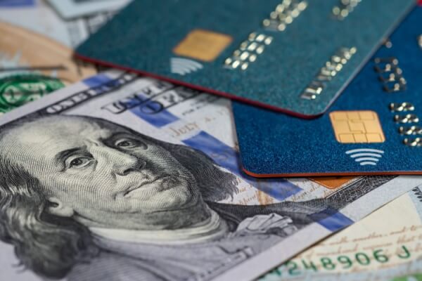 Credit cards and dollars in cash close up.